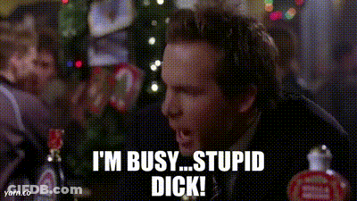 A Man In A Suit And Tie Is Standing In Front Of A Crowd Of People . GIF