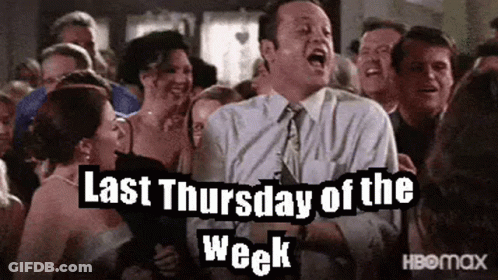 A Man In A Suit And Tie Is Standing In Front Of A Crowd Of People And Screaming . GIF