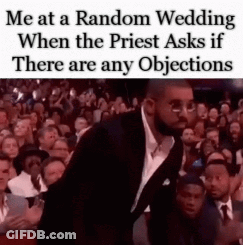 A Man In A Suit And Tie Is Standing In Front Of A Crowd Of People At A Wedding . GIF