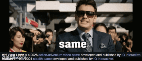 A Man In A Suit And Tie Is Standing In Front Of A Crowd Of People With The Word Same Written Below Him GIF