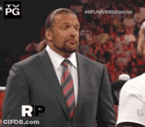 A Man In A Suit And Tie Is Standing In Front Of A Crowd With The Letters Rp On The Bottom GIF