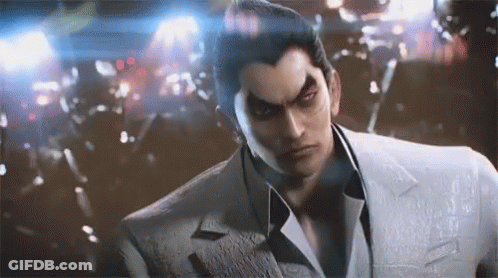 A Man In A Suit And Tie Is Standing In Front Of A Crowd . GIF