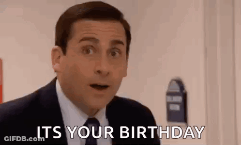 A Man In A Suit And Tie Is Standing In Front Of A Door And Saying `` It 'S Your Birthday '' . GIF