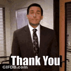 A Man In A Suit And Tie Is Standing In Front Of A Door And Says Thank You . GIF