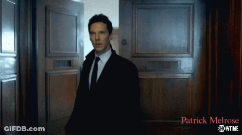 A Man In A Suit And Tie Is Standing In Front Of A Door That Says Patrick Melrose Showtime On It GIF