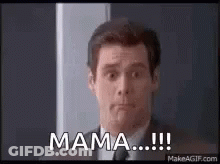 A Man In A Suit And Tie Is Standing In Front Of A Door . GIF