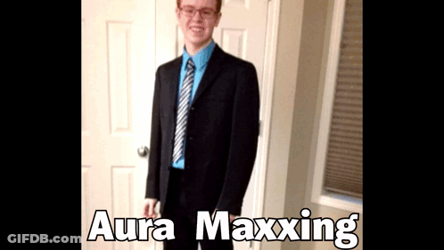 A Man In A Suit And Tie Is Standing In Front Of A Door With Aura Maxxing Written On The Bottom GIF