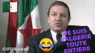 A Man In A Suit And Tie Is Standing In Front Of A Flag With A Laughing Smiley Face . GIF