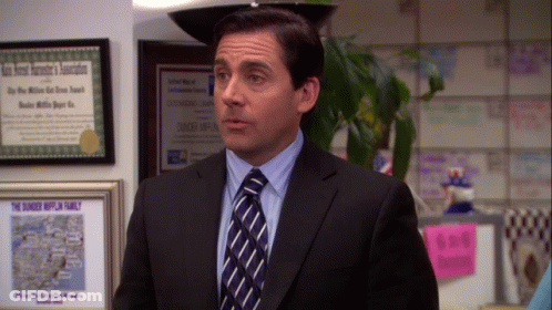 A Man In A Suit And Tie Is Standing In Front Of A Framed Certificate That Says " The Dunkey Hufflin Family " GIF