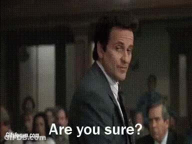 A Man In A Suit And Tie Is Standing In Front Of A Group Of People And Asking If They Are Sure . GIF