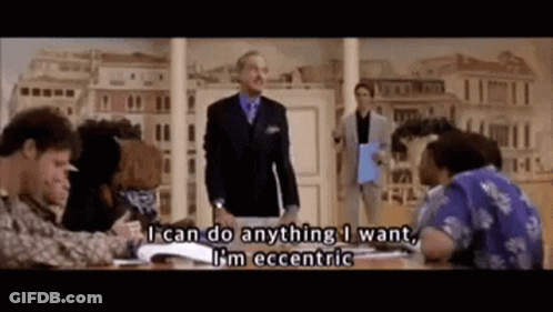 A Man In A Suit And Tie Is Standing In Front Of A Group Of People And Says I Can Do Anything I Want . GIF