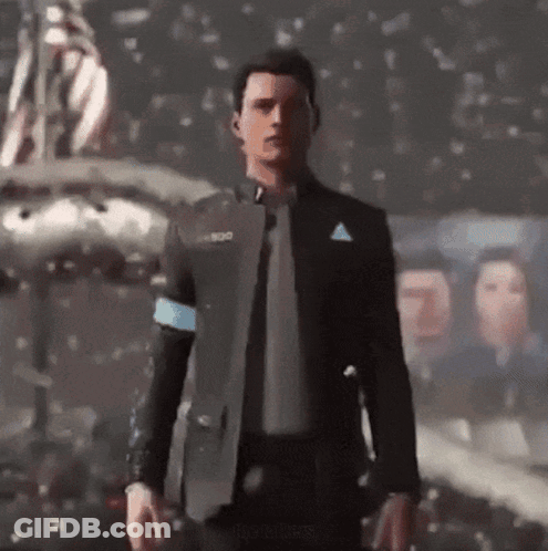 A Man In A Suit And Tie Is Standing In Front Of A Group Of People GIF