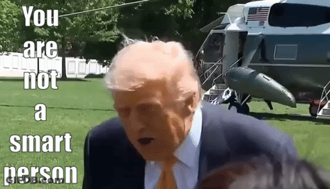 A Man In A Suit And Tie Is Standing In Front Of A Helicopter With The Words `` You Are Not A Smart Person '' . GIF