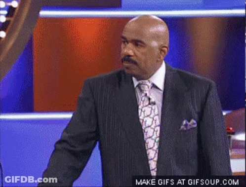 A Man In A Suit And Tie Is Standing In Front Of A Make Gifs At Gifsoup.com Button GIF