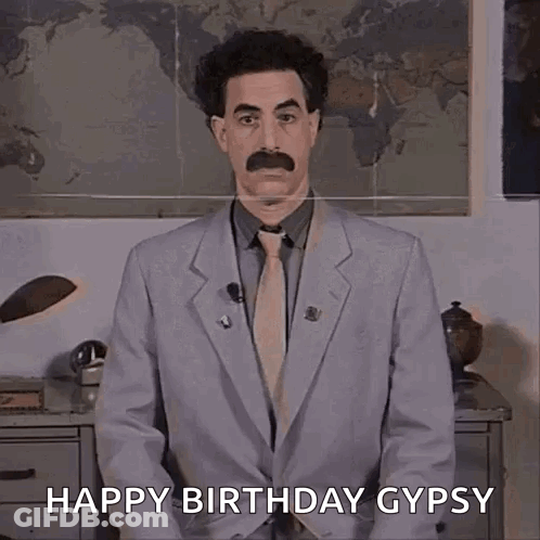 A Man In A Suit And Tie Is Standing In Front Of A Map And Saying Happy Birthday Gypsy . GIF