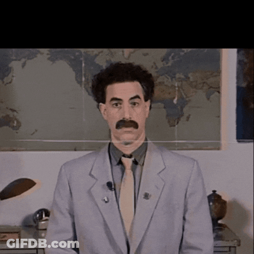 A Man In A Suit And Tie Is Standing In Front Of A Map GIF