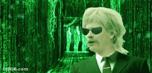 A Man In A Suit And Tie Is Standing In Front Of A Matrix Background GIF