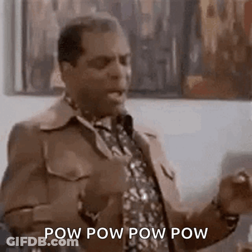 A Man In A Suit And Tie Is Standing In Front Of A Microphone And Talking . GIF