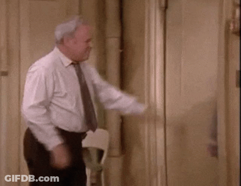 Man In Suit And Tie Standing In Front Of Mirror GIF