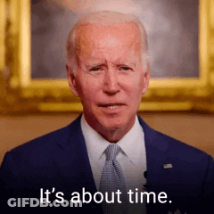 A Man In A Suit And Tie Is Standing In Front Of A Picture And Says `` It 'S About Time '' . GIF