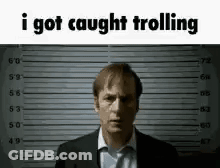 A Man In A Suit And Tie Is Standing In Front Of A Police Lineup And Says `` I Got Caught Trolling '' . GIF
