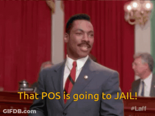 A Man In A Suit And Tie Is Standing In Front Of A Red Curtain And Says That Pos Is Going To Jail GIF