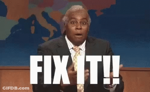 A Man In A Suit And Tie Is Standing In Front Of A Screen That Says Fix It ! GIF