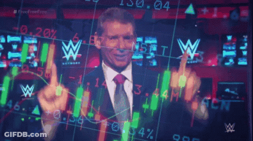 A Man In A Suit And Tie Is Standing In Front Of A Screen With A W Logo GIF