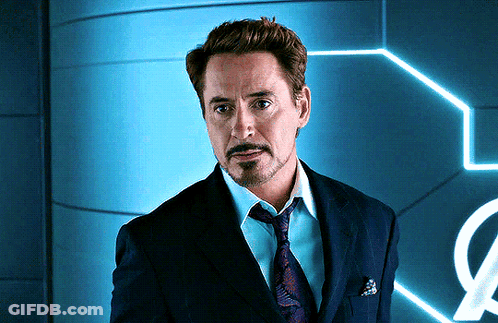 A Man In A Suit And Tie Is Standing In Front Of A Sign That Has The Letter O On It GIF