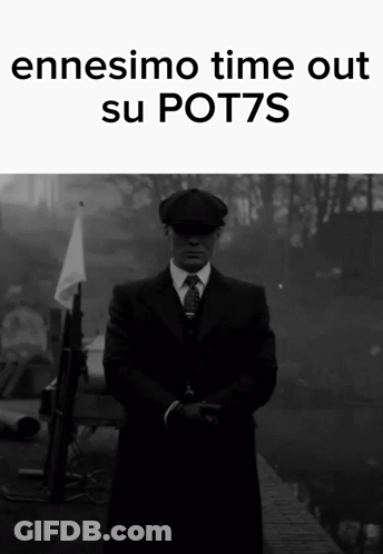 A Man In A Suit And Tie Is Standing In Front Of A Sign That Says " Ennesimo Time Out Su Pot7s " GIF