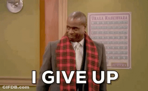 A Man In A Suit And Tie Is Standing In Front Of A Sign That Says I Give Up . GIF