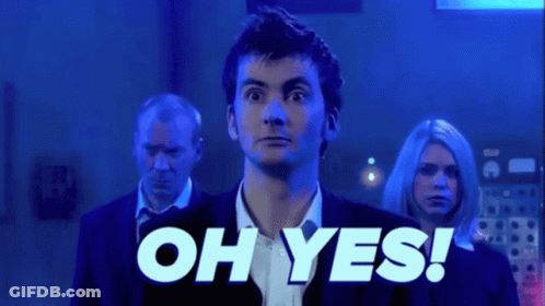 A Man In A Suit And Tie Is Standing In Front Of A Sign That Says Oh Yes GIF