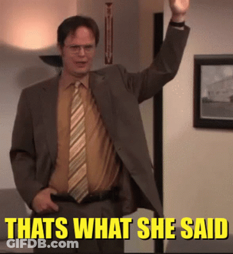 A Man In A Suit And Tie Is Standing In Front Of A Sign That Says " That 'S What She Said " GIF