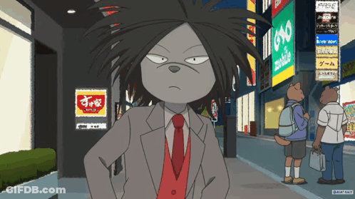 A Man In A Suit And Tie Is Standing In Front Of A Sign That Says Yoko GIF