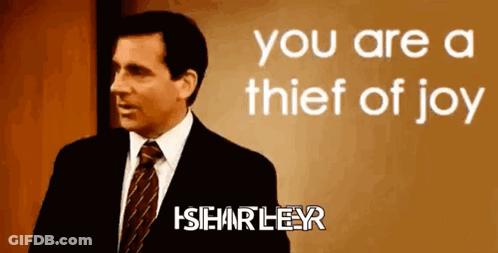 A Man In A Suit And Tie Is Standing In Front Of A Sign That Says " You Are A Thief Of Joy " GIF