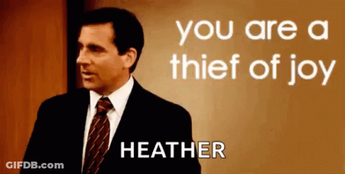 A Man In A Suit And Tie Is Standing In Front Of A Sign That Says `` You Are A Thief Of Joy Heather '' GIF