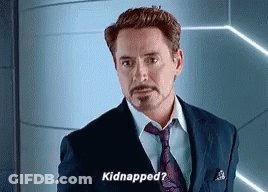 A Man In A Suit And Tie Is Standing In Front Of A Wall And Saying `` Kidnapped ? '' GIF