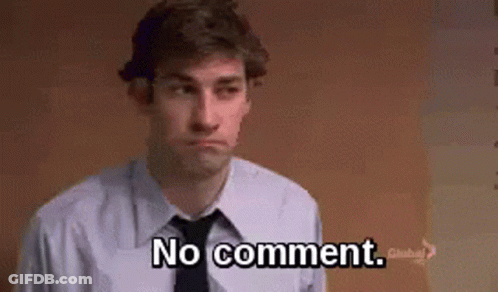 A Man In A Suit And Tie Is Standing In Front Of A Wall And Saying `` No Comment '' . GIF