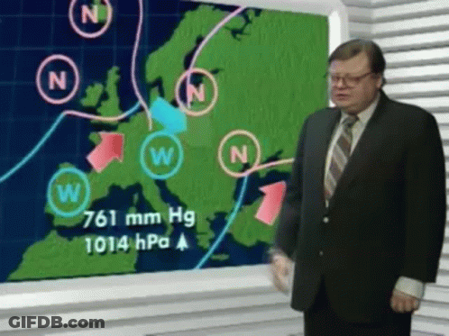 A Man In A Suit And Tie Is Standing In Front Of A Weather Map GIF