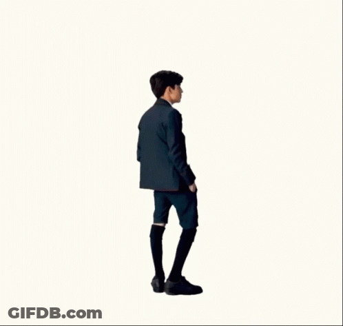 A Man In A Suit And Tie Is Standing In Front Of A White Background GIF