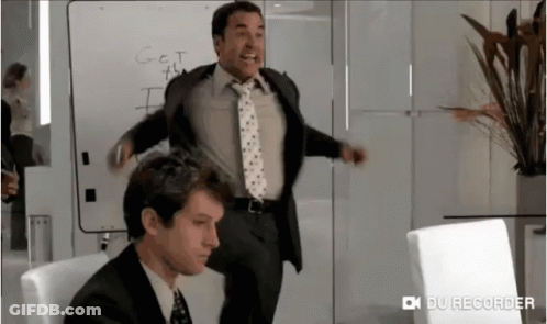 A Man In A Suit And Tie Is Standing In Front Of A White Board That Says " Got This " GIF