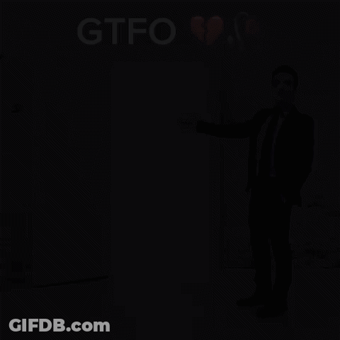 A Man In A Suit And Tie Is Standing In Front Of A White Door With The Word Gtfo Above It GIF