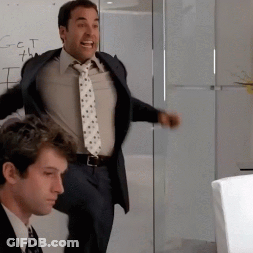 A Man In A Suit And Tie Is Standing In Front Of A Whiteboard That Says Got 7Th GIF