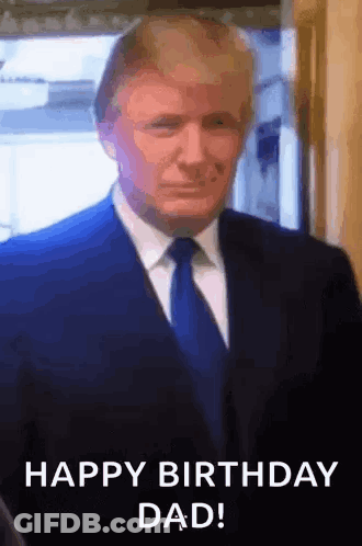 A Man In A Suit And Tie Is Standing In Front Of A Window And Says `` Happy Birthday Dad '' . GIF