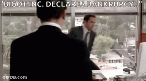A Man In A Suit And Tie Is Standing In Front Of A Window In An Office . GIF