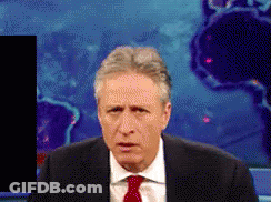 A Man In A Suit And Tie Is Standing In Front Of A World Map GIF
