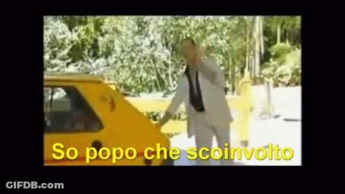 A Man In A Suit And Tie Is Standing In Front Of A Yellow Car With The Words So Popo Che Sconvolto Written In Yellow GIF