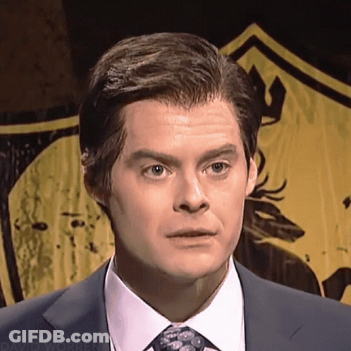 A Man In A Suit And Tie Is Standing In Front Of A Yellow Shield That Says David Worren GIF