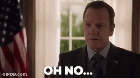 A Man In A Suit And Tie Is Standing In Front Of An American Flag And Saying `` Oh No '' . GIF
