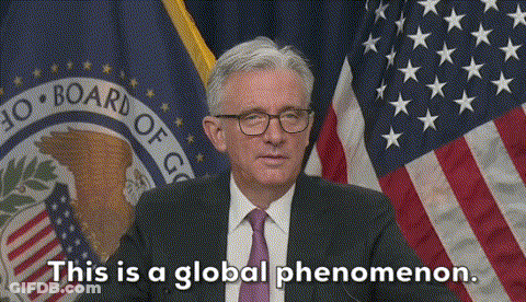 A Man In A Suit And Tie Is Standing In Front Of An American Flag And Says This Is A Global Phenomenon GIF